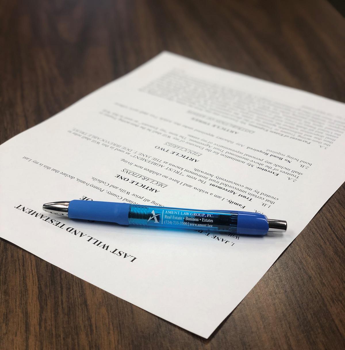 Estate planning documents and an Ament Law Group pen